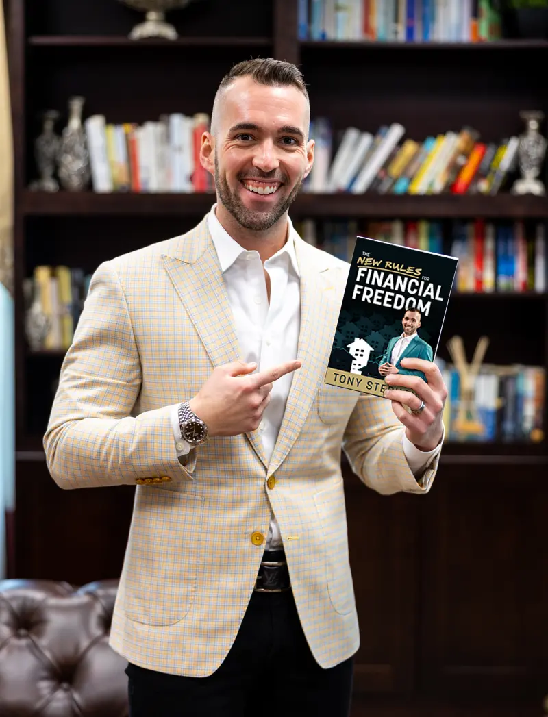 Tony Stephan holding The New Rules for Financial Freedom